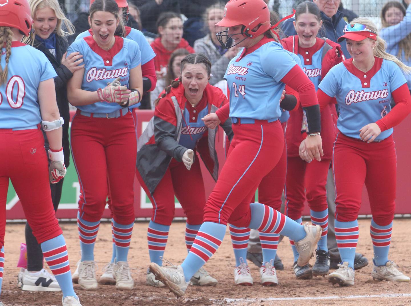 Ottawa's Bobbi Snook steps on home plate while being greeted by teammates after hitting a two-run homerun against L-P in a game last season at the L-P Athletic Complex in La Salle.