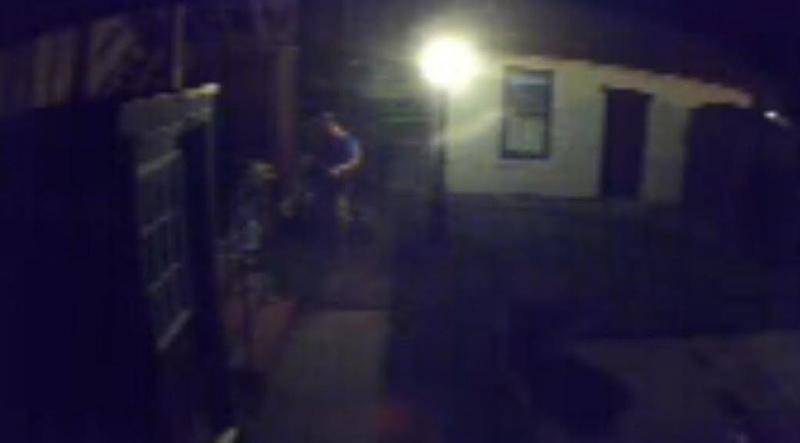 The video is dark and grainy, but a suspect who appears to be a male in a blue shirt, light colored shorts, and carrying a light colored backpack was caught on camera allegedly stealing a bicycle from a yard in Morris.