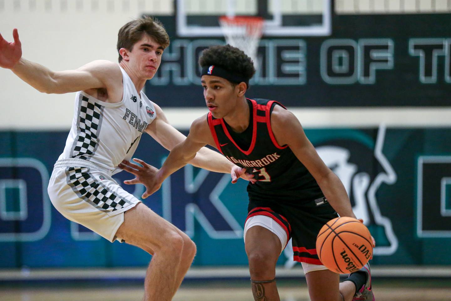 Bolingbrook's Davion Thompson (3) drives past the defense of Fenwick's Jimmy Watts (4) during their Jack Tosh Holiday Classic basketball tournament Championship game between Fenwick at Bolingbrook. Tuesday Dec 31, 2024 in Elmhurst.