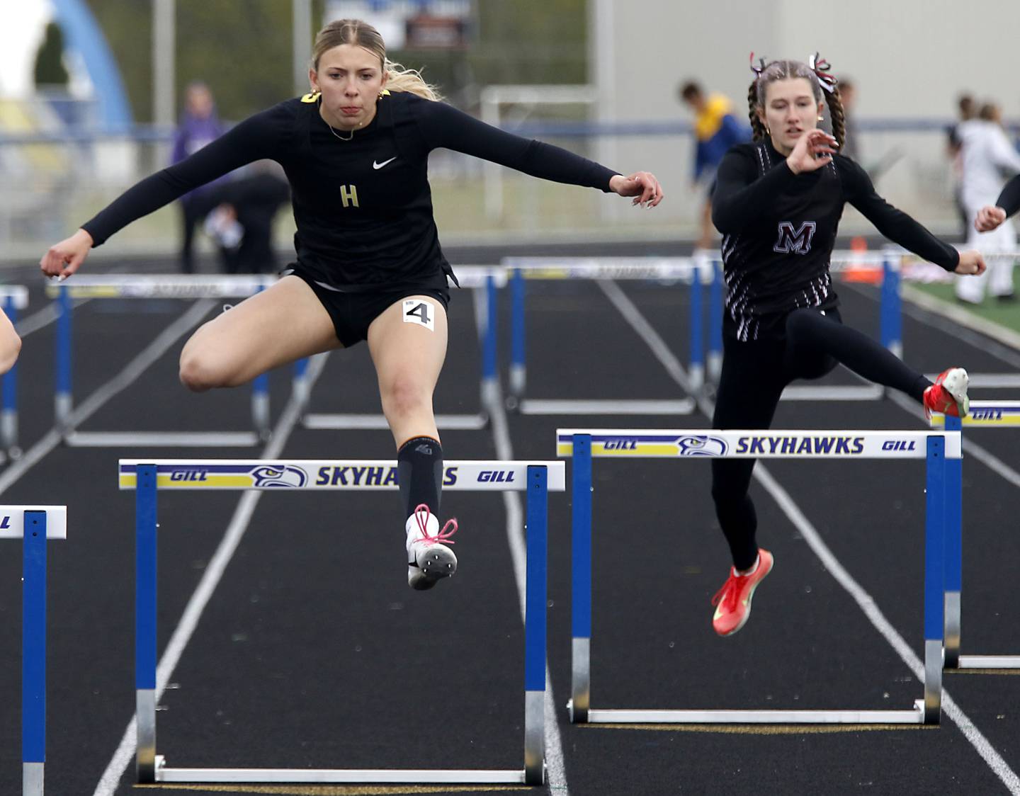 Harvard’s Ella Martin (left) and Marengo’s Olivia Walter race the 300 meter hurdles during the IHSA Class 2A Johnsburg Girls Track and Field Sectional Meet on Wednesday, May 13, 2026, at Johnsburg High School.