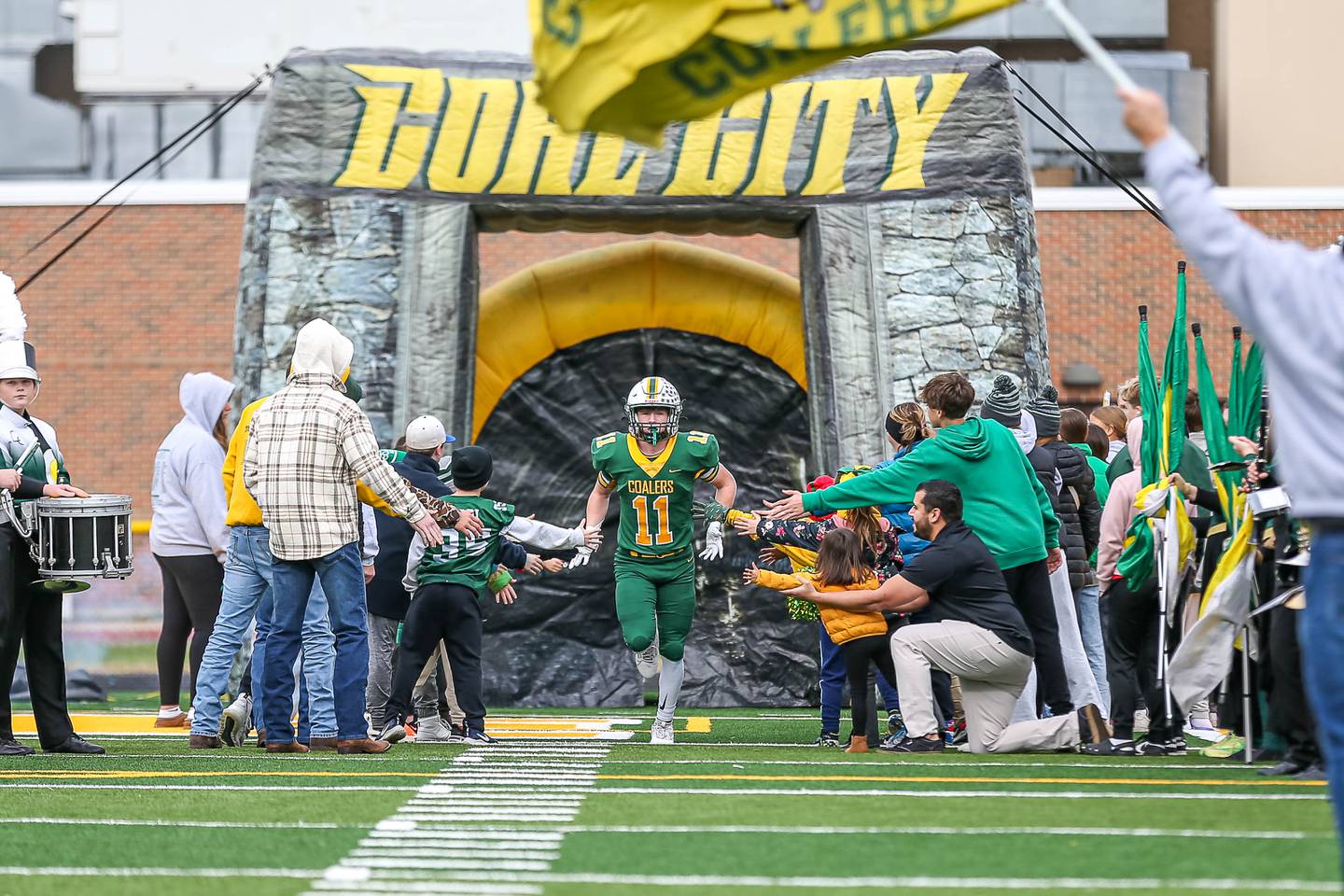 Coal City's Mason Garner (11) runs out onto the field during pregame introductions before their Class 4A quarterfinal football game versus Dixon on Saturday, Nov 16, 2024  in Coal City.