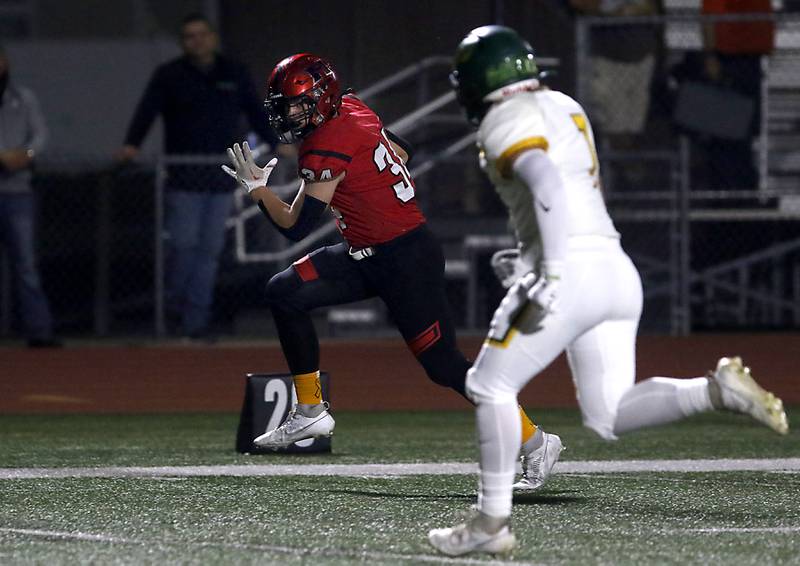 Huntley's Haiden Janke runs for a touchdown as Crystal Lake South's Dan Zebrowski give chase during a Fox Valley Conference football game on Friday, Sept. 29, 2023, at Huntley High School.