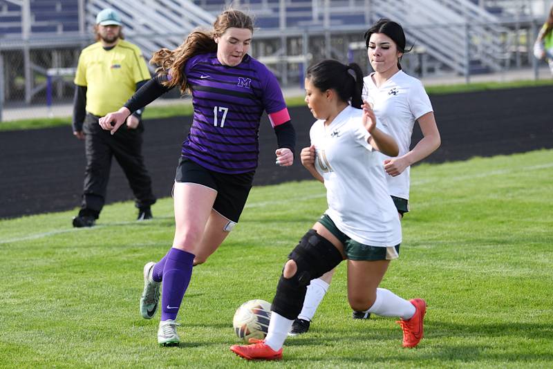 Manteno's Emily Horath, left, works around Bishop McNamara's Dayana Alvarado, center, and Stephanie Zamora during a game at Manteno Wednesday, April 29, 2026.