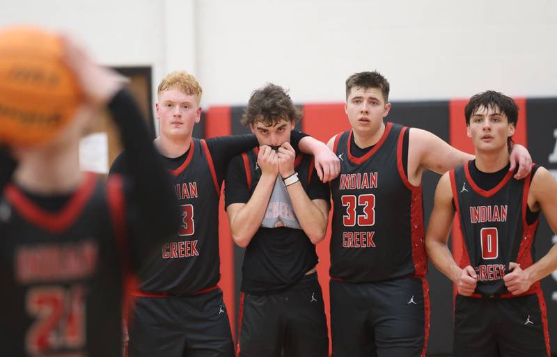 Indian Creek players (from left) Isaac Willis, Logan Schrader, Payton Hueber, and Cooper Rissman watch with suspense as teammate Parker Murry lets go of a free throw late in the 4th quarter against Marquette during the Class 1A Sectional game on Friday, March 6, 2026 at Amboy High School.