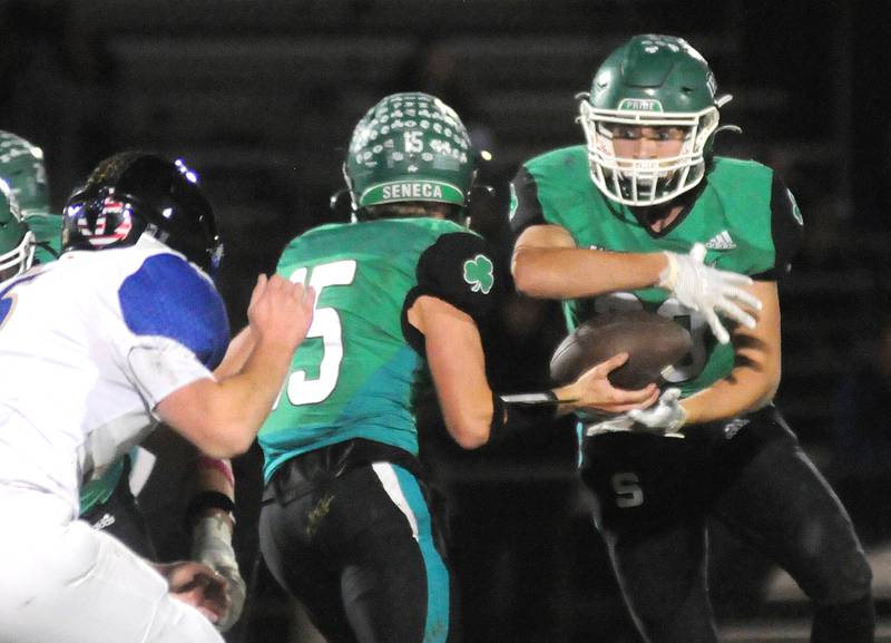 Seneca's Paxton Giertz (15) passes off to Cameron Shriey against Dupec on Friday, Oct. 24, 2024.