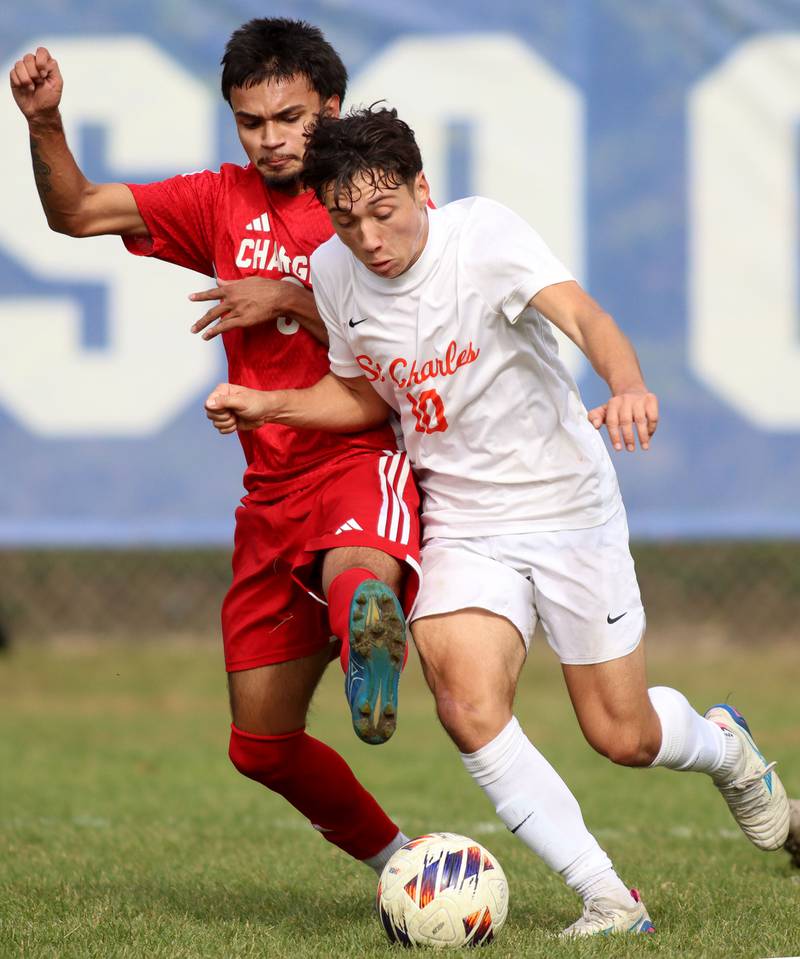 Dundee-Crown’s Guadalupe Martinez, left, battles St. Charles East’s Huxley Kapoor in IHSA Class 3A Regional Championship soccer at Dundee-Crown High School in Carpentersville on Saturday, October 25, 2025.