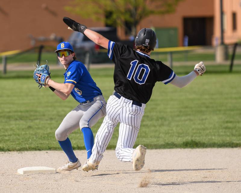 Somonauk's Silas Johnson (8) gets Newark's Toby Steffen (10) out at second base but drops the ball during the transfer to come up short on a double play on Tuesday May 13, 2025, in the game held at Somonauk High School.