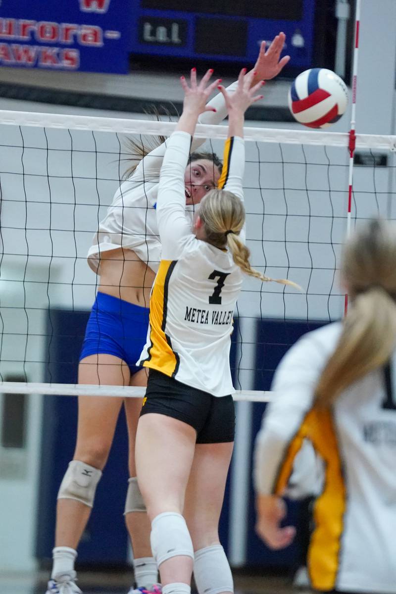 St. Charles North's Haley Burgdorf (23) goes up for a kill attempt against Metea Valley's Katie Schuele (7) during a Class 4A West Aurora Sectional semifinal volleyball match at West Aurora High School on Tuesday, Nov. 5, 2024.
