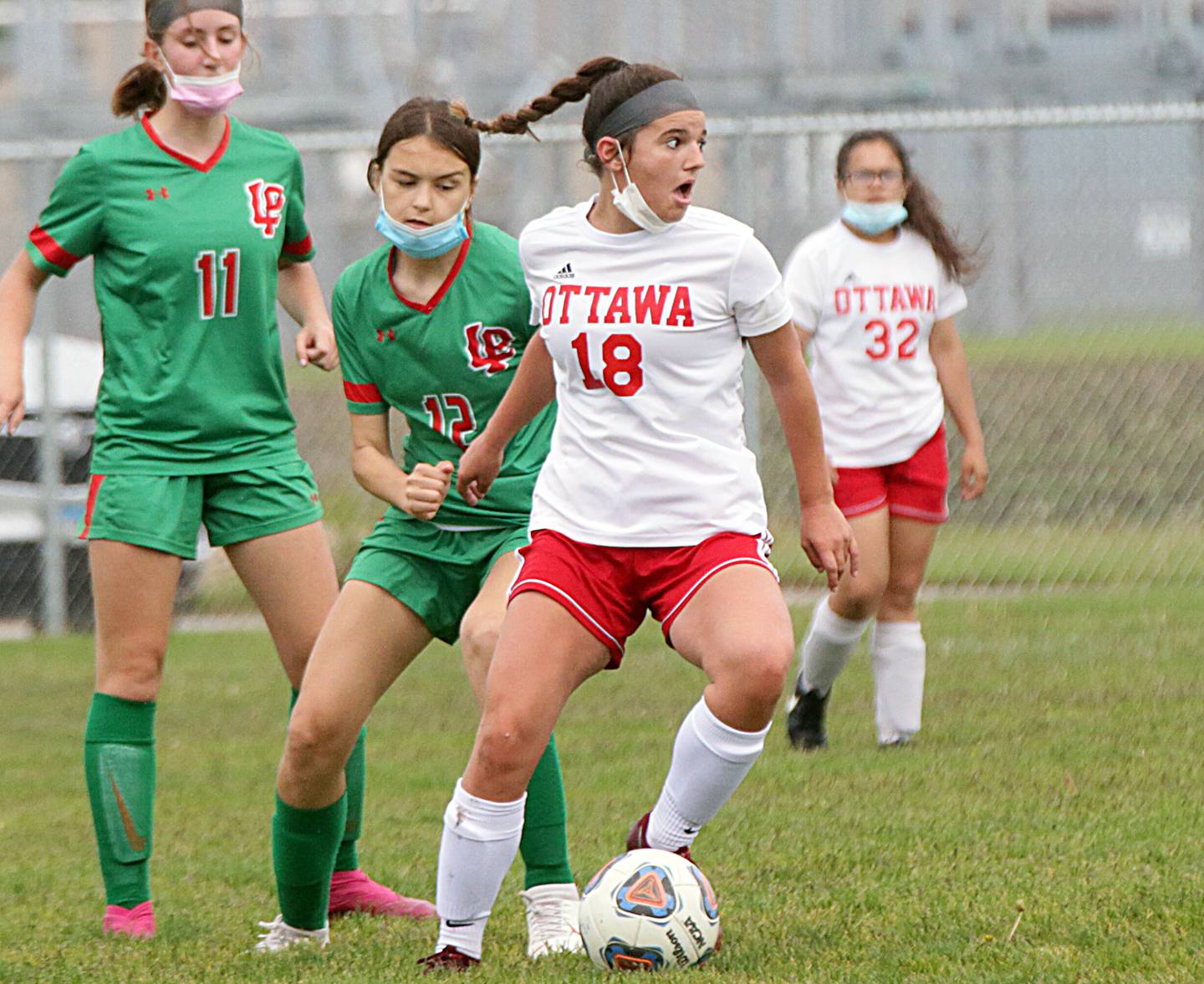 Ottawa's Gabi Krueger kicks the ball downfield as L-P's Abigail Poole defends.