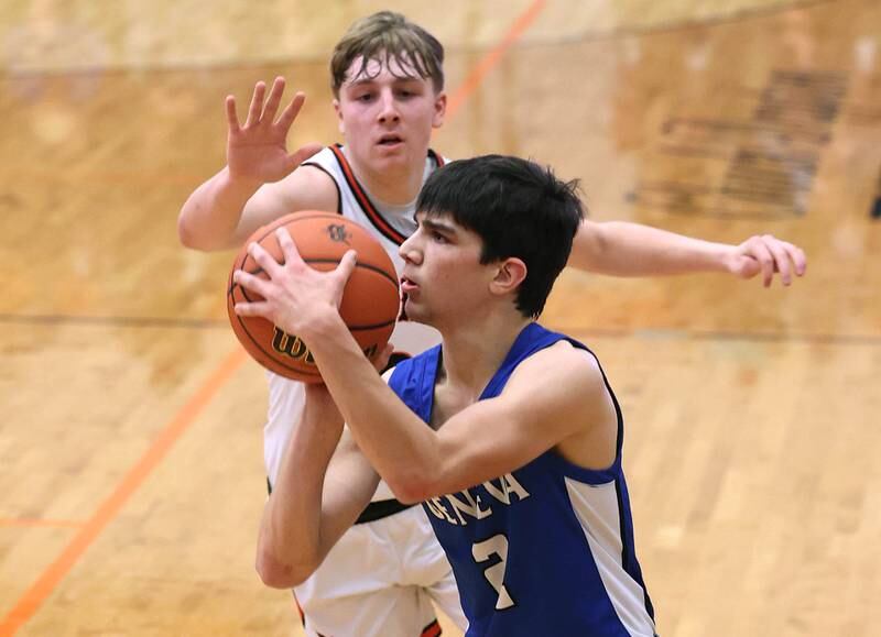Geneva’s Gabe Jensen shoots a three pointer as DeKalb’s Sean Reynolds provides the defense Thursday Dec. 28, 2023, during their second round game against Geneva in the 96th Chuck Dayton Classic boys basketball tournament at DeKalb High School.