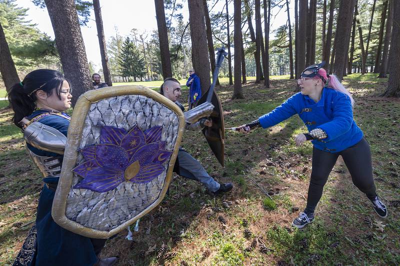 Alise Sherman (left) and Zander Dixon engage in battle with Amber Abell Saturday, April 13, 2024 during a game play clash in the campaign. The live action role playing group meets once a month at the Lowell Park pinetum but also hosts special events throughout year. Go to cerlarp.com for more info.