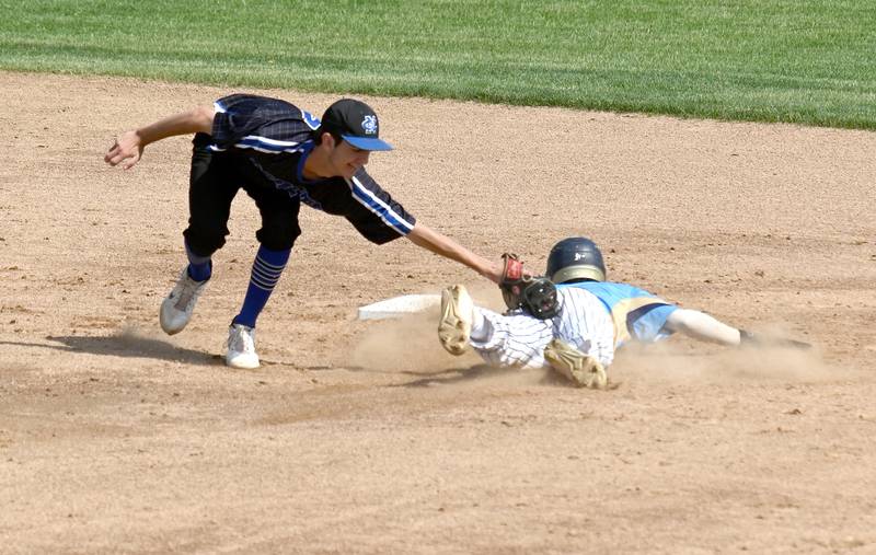 Newman's Kyle Wolfe applies a tag to Marquette's Julian Alexander Monday during the supersectional game at Rockford Rivets Stadium.