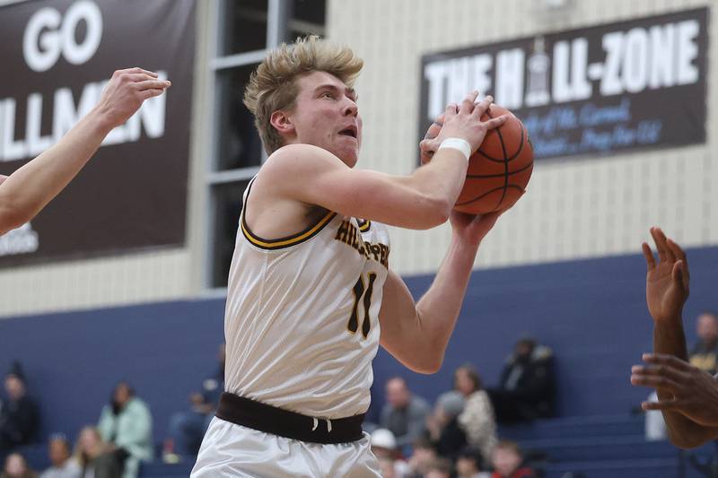 Joliet Catholic’s Drew Wills pulls in a rebound against Plainfield South on Wednesday, Jan. 17th, 2024 in Joliet.