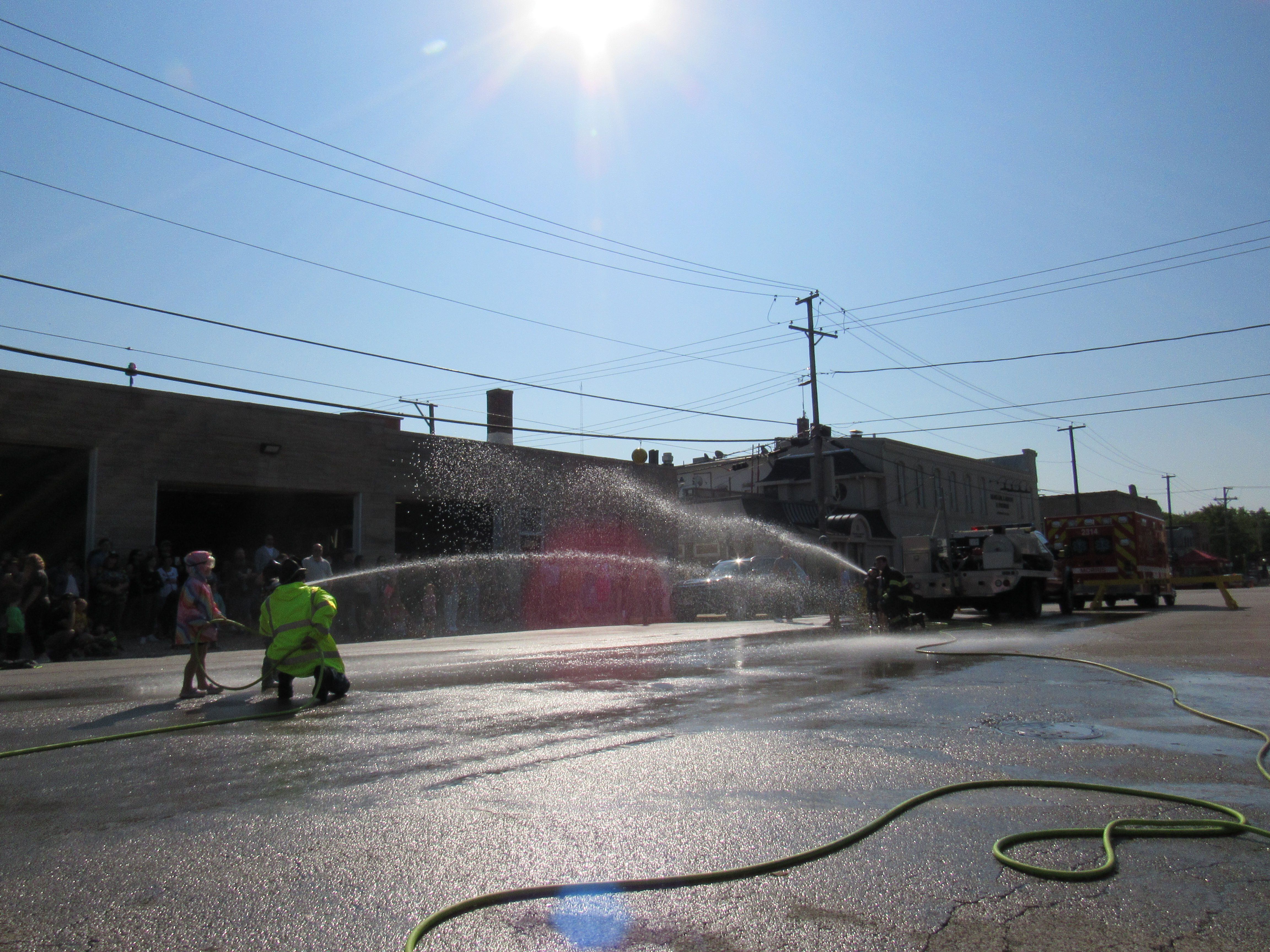 Sadie (left) listens as the firefighter provides guidance on how to win.