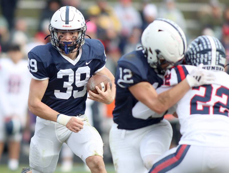 Cary-Grove’s Holden Boone runs the ball against Belvidere North in IHSA Class 6A quarterfinal playoff football action on Saturday, Nov. 16, 2024, at Al Bohrer Field on the campus of Cary-Grove High School in Cary.