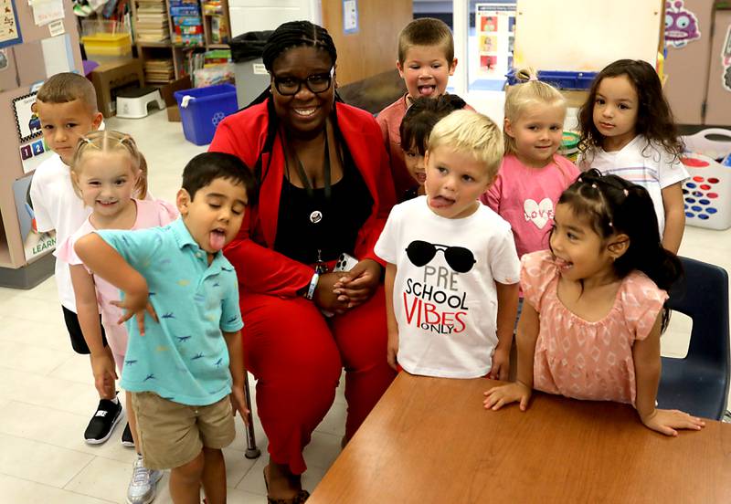 Preschoolers make goofy faces as they pose for a photograph with District 300 Superintendent Martina Smith  during the first day of school on Tuesday, Aug. 12, 2025, at Westfield Community School in Algonquin.