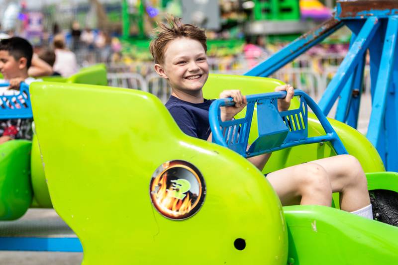 Lockport resident Trent Frushour rides the Sizzler during Old Canal Days in Lockport on June, 7, 2025.