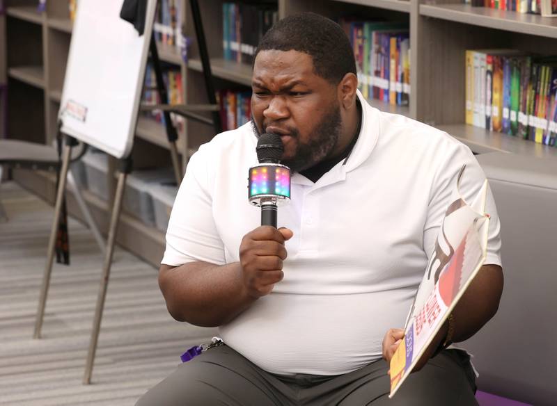 Mitchell Elementary School librarian Alontae McCain reads to first graders Thursday, March 19, 2026, in the library at the school in DeKalb.