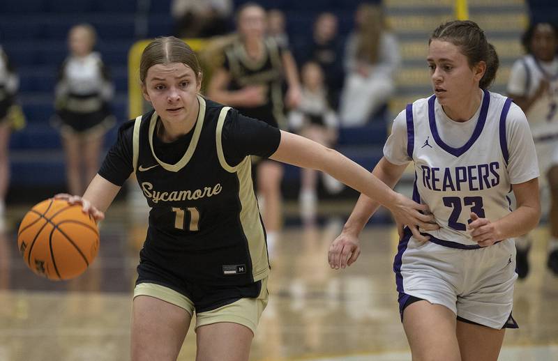 Sycamore’s Macy Calendo brings the ball up court against Plano’s Josie Larson Monday, Feb. 17, 2025, during a 3A semifinal in Sterling.