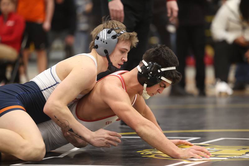 Brayden Swanson of Oswego works over Donncha Souza of Yorkville in the 144-pound weight SPC Conference championship match at Joliet West on Saturday, Jan 25, 2025.