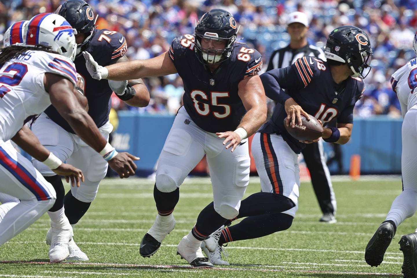Chicago Bears center Coleman Shelton (65) blocks during the first half of an NFL football pre-season game against the Buffalo Bills in Orchard Park N.Y., Saturday Aug. 10, 2024. (AP Photo/ Jeffrey T. Barnes)