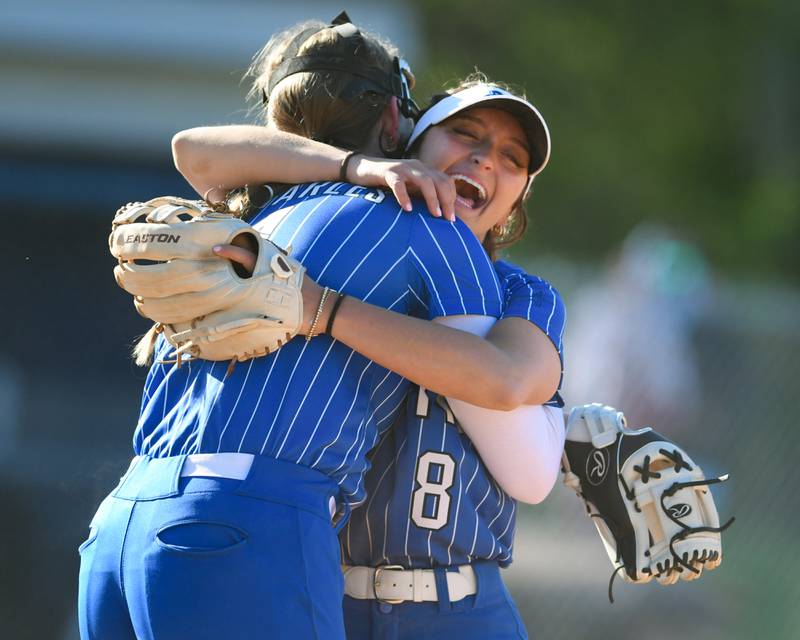 St. Charles North's pitcher Paige Murray (15) gets a hug from teammate Ginger Ritter (8) after catching a pop up during the game on Wednesday April 24, 2024, while traveling to take on Lake Park High School.