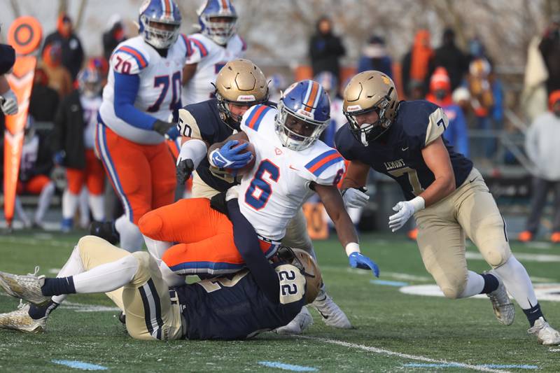 East St. Louis’ Taryan Martin is rapped up by a host of Lemont defenders in the Class 6A semifinal in Lemont on Saturday.