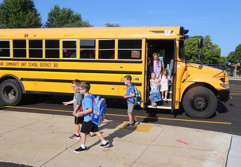 Students emerge from the first school bus that pulled up at Kaneland John Shields Elementary School in Sugar Grove for the first day of the 2023-24 school year on Wednesday, Aug. 16, 2023.