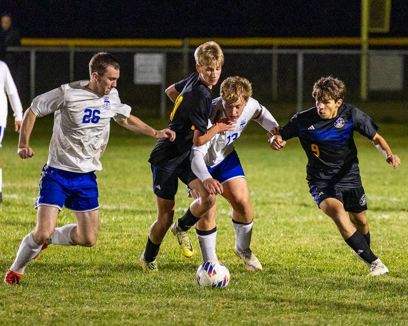 Carson Harper (21) of Somonauk/Leland/Newark and Luke Badal (23) of Hinckley-Big Rock fight over possession of ball as (left) Austin Kennedy (26) of Hinckley-Big Rock and (right) (9) of Somonauk/Leland/Newark trail during the Little Ten Conference Championship match on Thursday, Oct. 9, 2025 at Hinckley-Big Rock School in Hinckley.