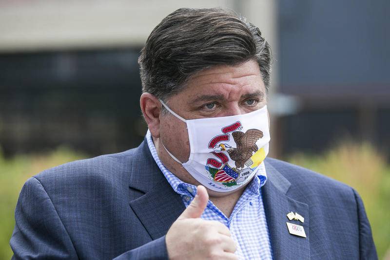 JB Pritzker gestures July 16 while meeting with people at City Market in Rockford after his visit to promote the 2020 Census.