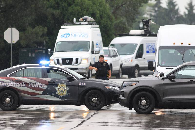 Bolingbrook Police squad cars block the roadway at the WeatherTech complex on Saturday, June 25, 2022. Early reports indicated three people were shot and one person was killed.