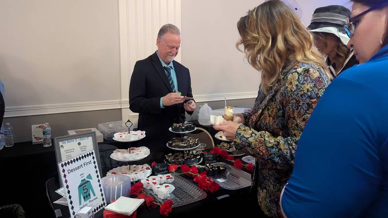 Rick Johnson of Wilmington serves sweet bites from Dessert First to attendees at the Shorewood HUGS annual chocolate ball on Saturday, February 1, 2025, in Joliet.