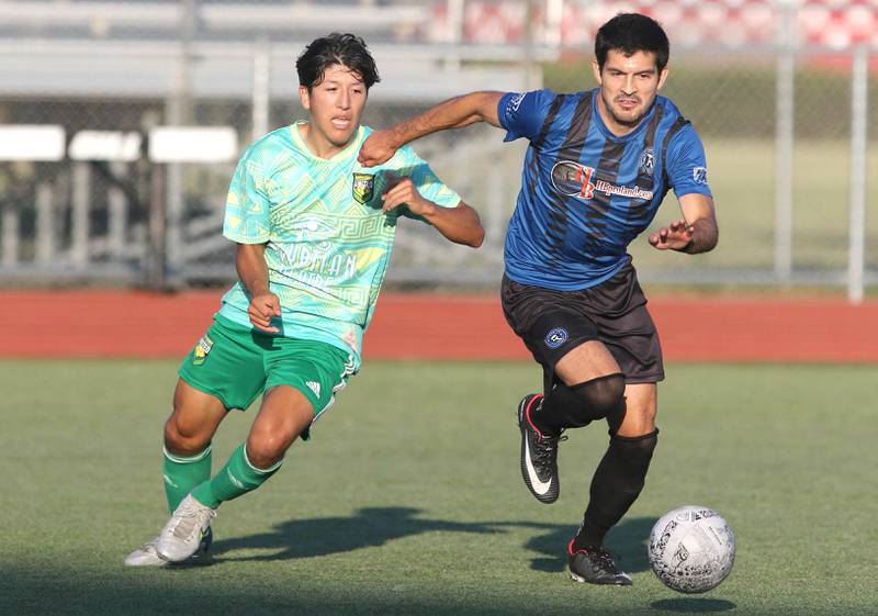 DeKalb County United's Oscar Montejano (left) and Rockford FC's Jose Gutierrez chase down the ball Wednesday, July 13, 2022, as the teams battle for the 815 Cup at the Northern Illinois University Soccer and Track and Field complex in DeKalb.