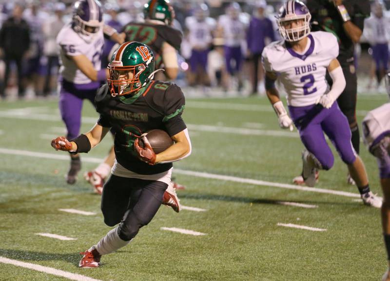 L-P's Adrian Arzola runs the ball as Rochelle's Jack Pavlak trails behind on Friday, Sept. 27, 2024 at Howard Fellows Stadium.