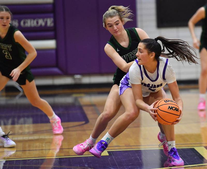 Downers Grove North’s Campbell Thulin is fouled from behind by Glenbard West’s Nina Hendricksen duri. ng a game on January 17, 2026 at Downers Grove North High School in Downers Grove .
