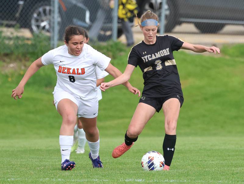 Sycamore's Marin Gautcher kicks the ball away from DeKalb's Alexia Ortiz Thursday, May 7, 2026, during their game at Sycamore High School.