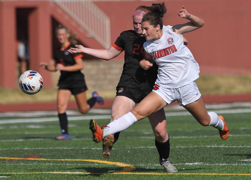 Barrington’s Piper Lucier kicks the ball away from Libertyville’s Ellia Rebman in the IHSA girls state soccer semifinal game at North Central College in Naperville on Friday, June 2, 2023.