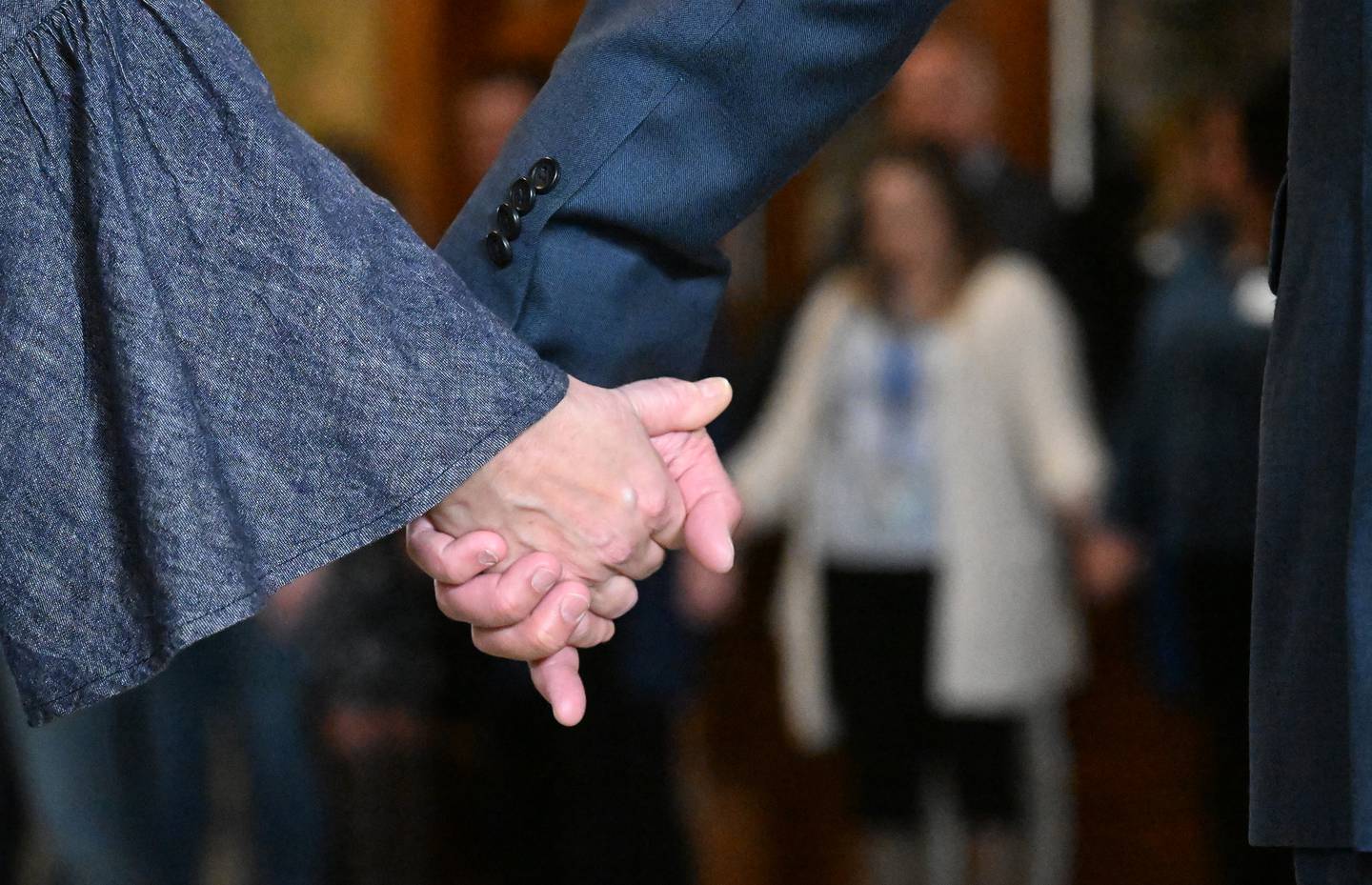About 100 people join hands for a moment of silence during CASA Kane Countys Hands Around the Courthouse event Thursday in Geneva. The event is held annually to raise awareness of Child Abuse Prevention Month.