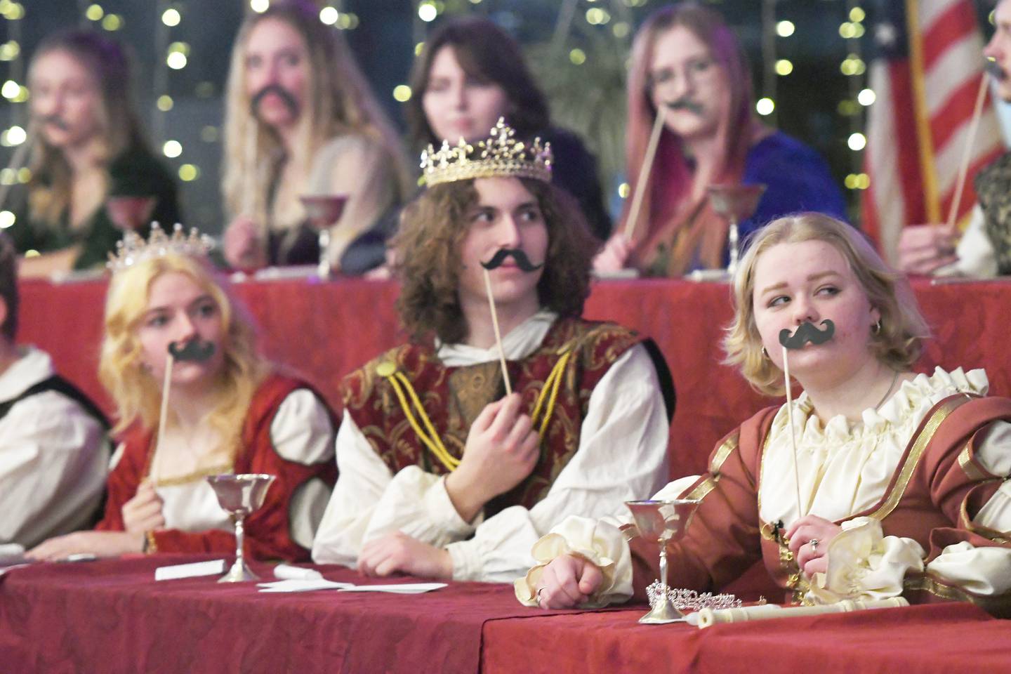 Oregon High School Madrigals Mackenzie Alford (queen), Brandon Rowe (king), and Abigail Rogers (princess) perform a scene during the Dec. 9 performance at Stronghold Camp & Retreat Center.