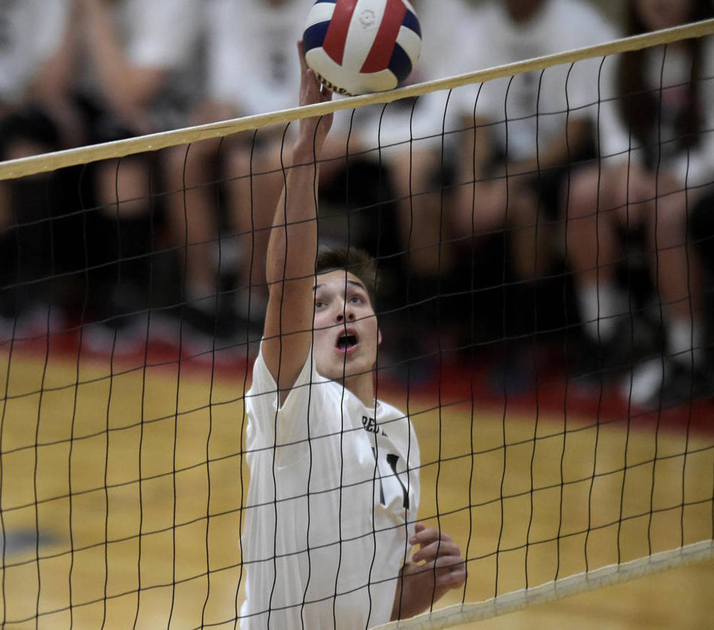 Huntley junior Charlie Johnson gets the ball over the net during a home match Monday, May 1, 2017, against Harlem.