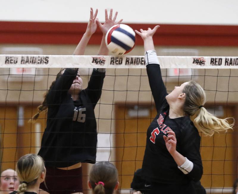 Prairie Ridge's Adeline Grider blocks the ball as Huntley's Emily Ernst tries to tip it over the net during a Fox Valley Conference volleyball match on Tuesday, Oct. 8, 2024, at Huntley High School.