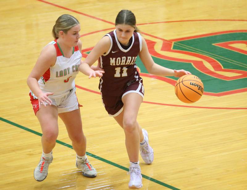 Morris's Alyssa Jepson dribbles around L-P's Emma Jereb on Friday, Dec. 6, 2024 in Sellett Gymnasium at L-P High School.