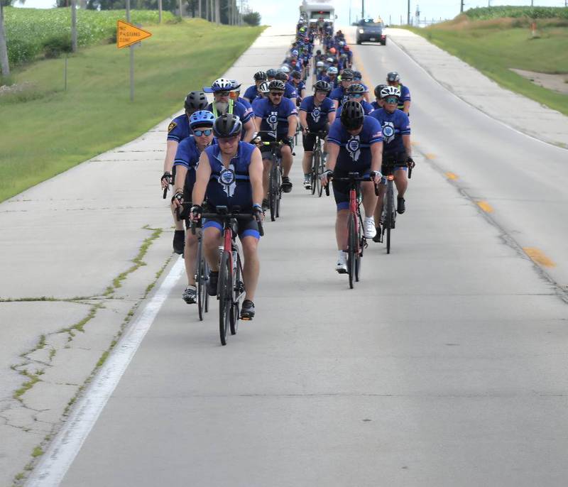 DeKalb County Sheriff Andy Sullivan (left front) joins nearly 100 cyclists biking from Normal through La Salle County to DeKalb on Saturday, July 12, 2025, for Cycle Across Illinois, a charity campaign to honor fallen police officers and raise funds for their families.