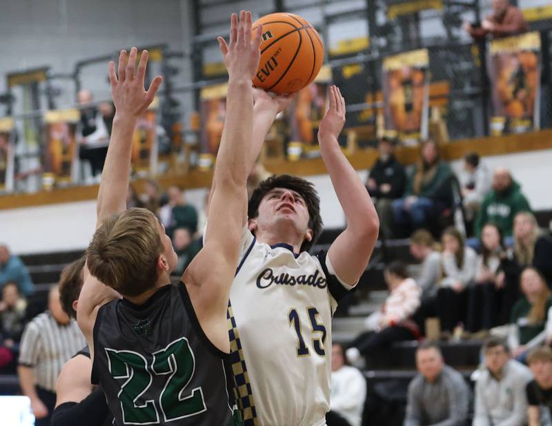Marquette's Alec Novotney runs in the lane to score over Midland's Trent Allen during the Tri-County Conference Tournament on Monday, Jan. 26, 2026 at Putnam County High School
