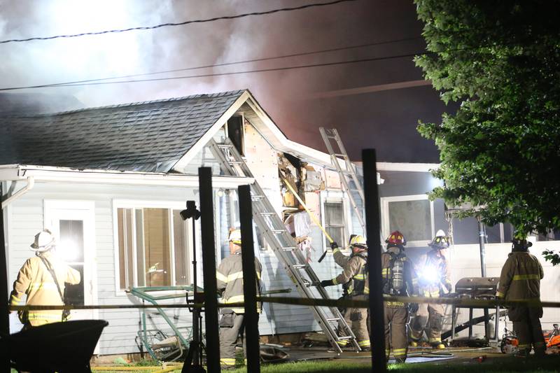 Firefighters work the scene of a structure fire in the 100 block of West Cleveland Street on Thursday, May 15, 2025 in Spring Valley. The fire broke out shortly before 8:30p.m. Fire departments from La Salle Bureau and Putnam Counties responded to the scene. A mutual aid box alarm system (MABAS) call was issued prompting the response.
