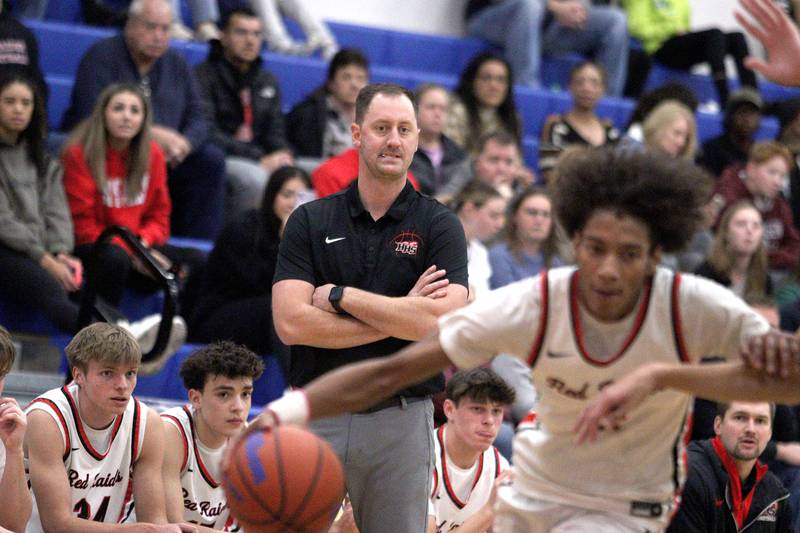 Huntley’s Head Coach Collin Kalamatas keeps tabs on the action against Crystal Lake South in varsity basketball tournament title game action at Johnsburg Friday.