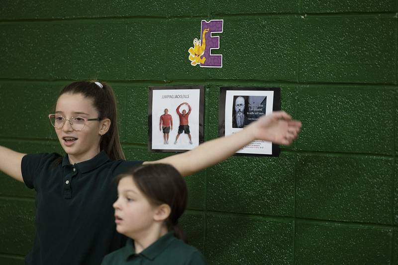 St. Andrew Catholic School students exercise at Thursday, Feb. 2, 2023 during an event recognizing Catholic Schools Week. Students went from station to station in the gym where they learned about a Catholic saint before doing one minute of some kind of exercise.