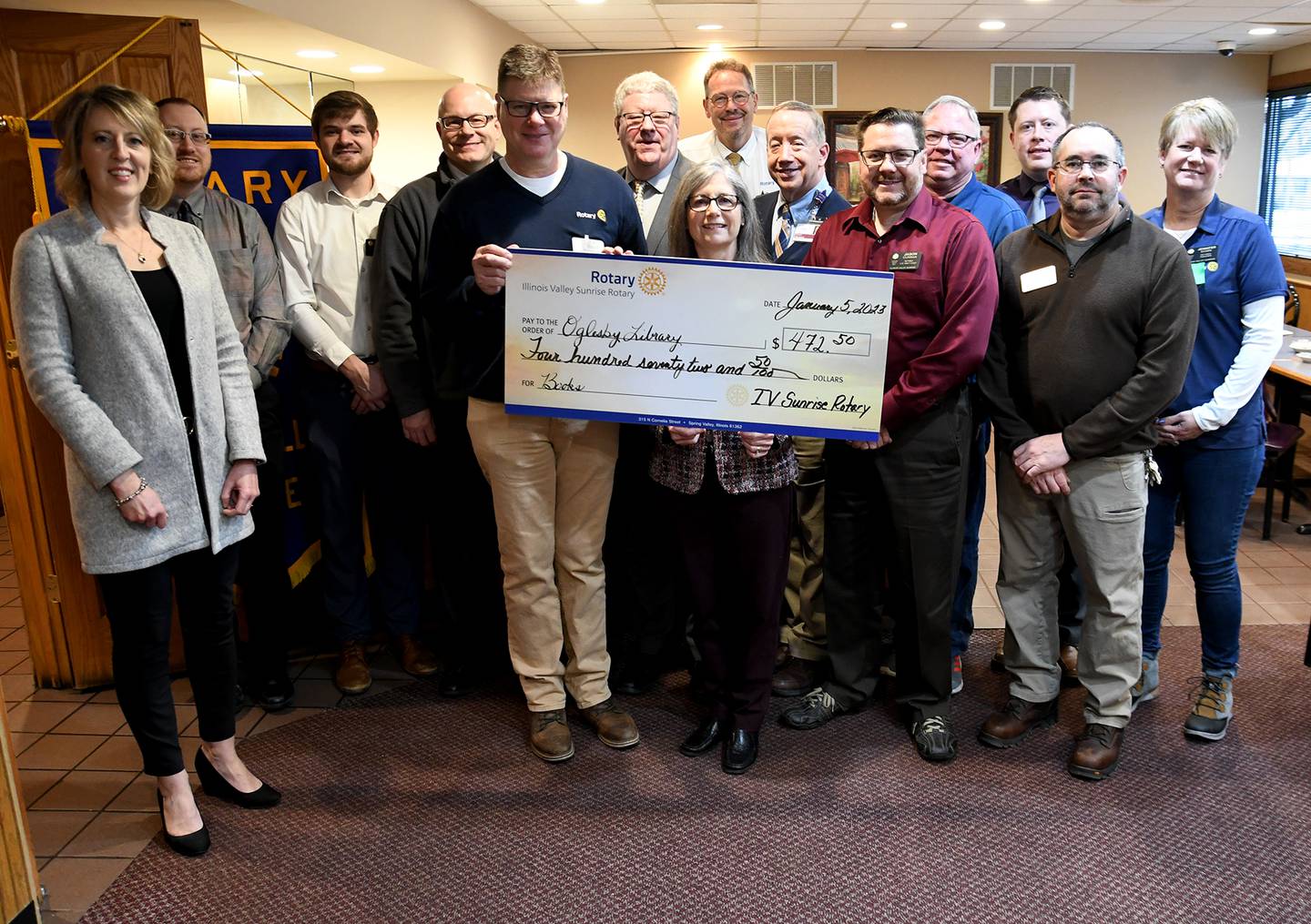 Oglesby Public Library Director Lynn Sheedy received a $472 check from the Illinois Valley Sunrise Rotary for the community's library.