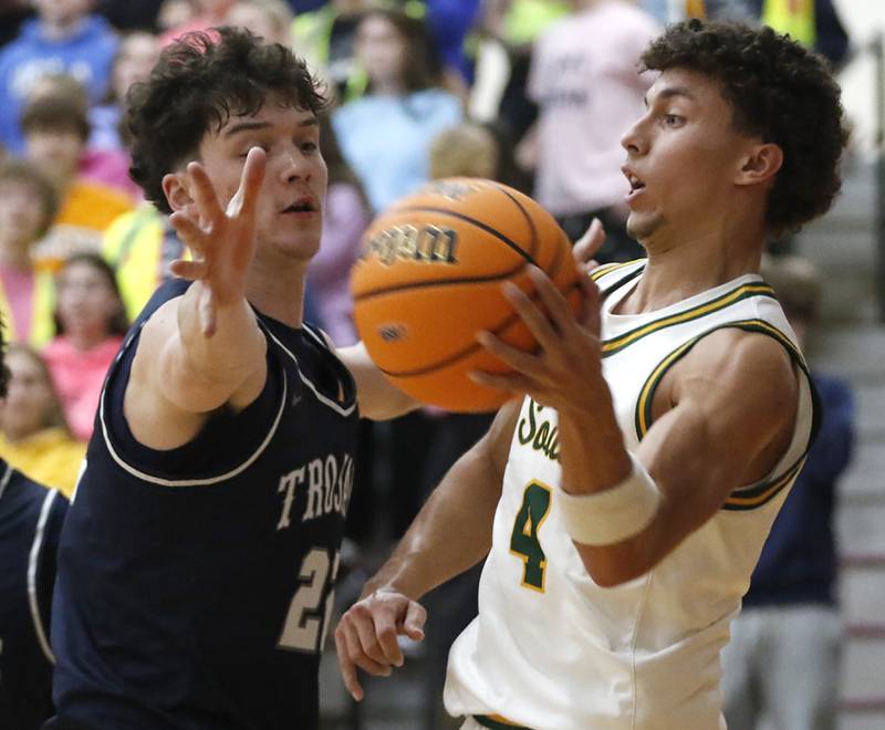 Crystal Lake South's Anthony Demirov passes the ball as he is defended by Cary-Grove's Adam Bauer during the IHSA Class 3A Prairie Ridge Regional championship basketball game on Friday, Feb. 28, 2025, at Prairie Ridge High School in Crystal Lake.