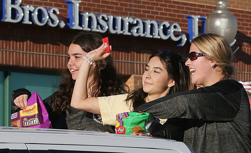 St. Bede ambassadors throw candy in the Homecoming parade on Friday, Sept. 30, 2022 downtown Peru.